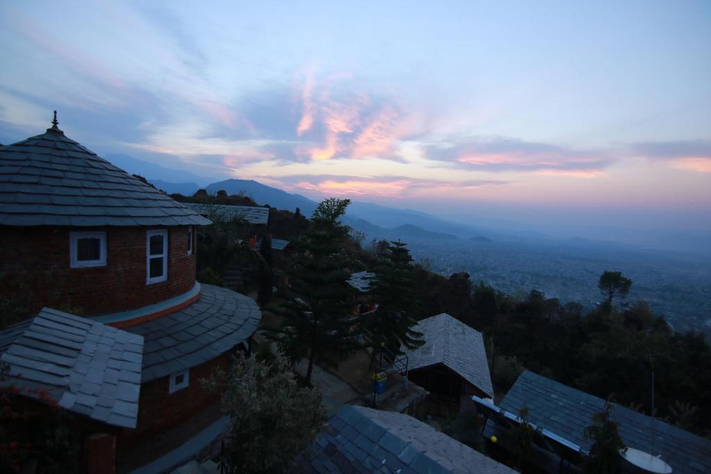 a view of a building with a sunset in the background at Rock Garden Resort in Pokhara