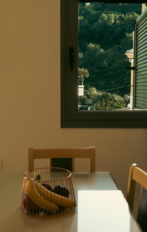 a table with a basket on it with a window at Baia Blu Apartments in Syvota