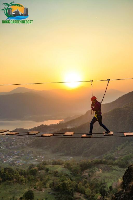 a person on skis holding on to a rope at Rock Garden Resort in Pokhara