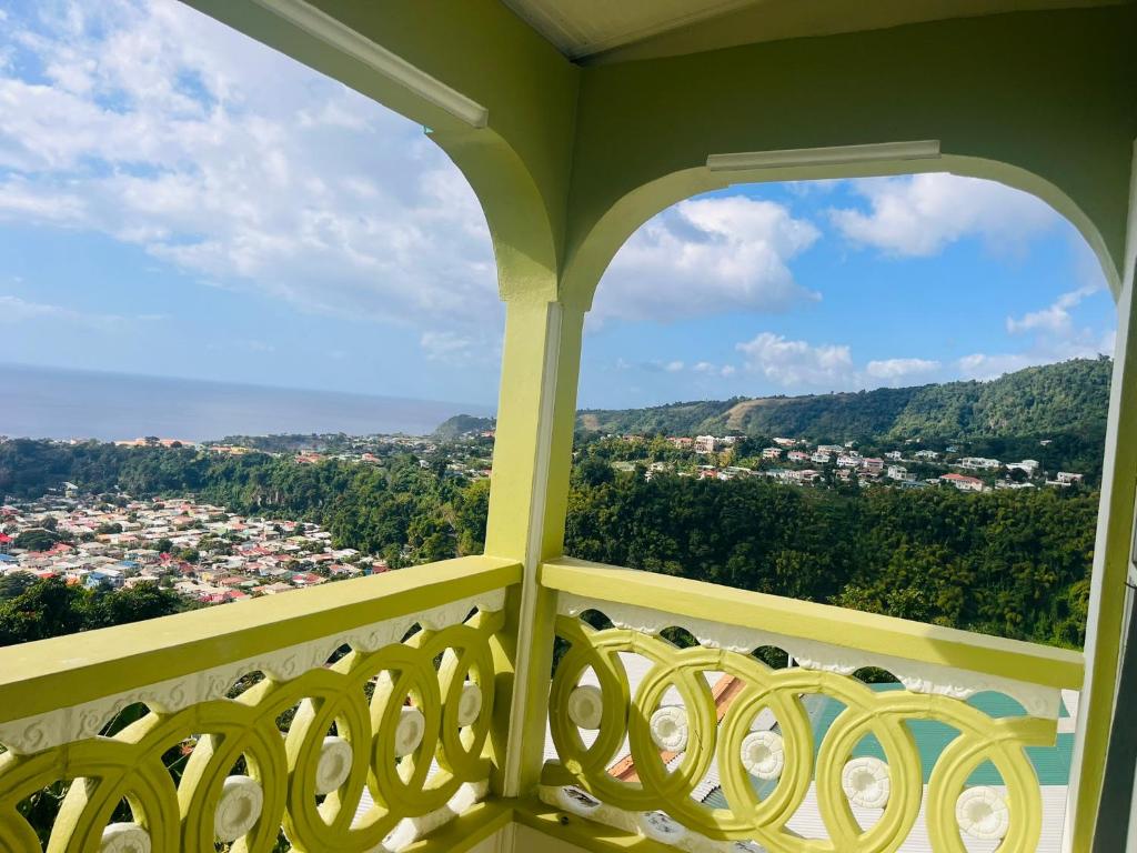 a balcony with a view of a city at City View Accommodations in Roseau
