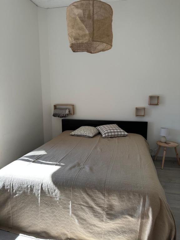 a bedroom with a large bed with a brown comforter at Casa Valverde I in Amarante
