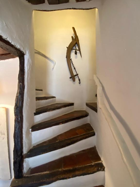 a set of stairs with a clock on the wall at Campagne Salettes in Lorgues