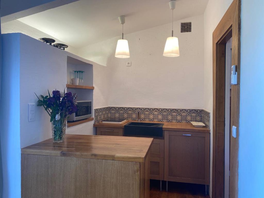 a kitchen with a vase of flowers on a counter at Campagne Salettes in Lorgues