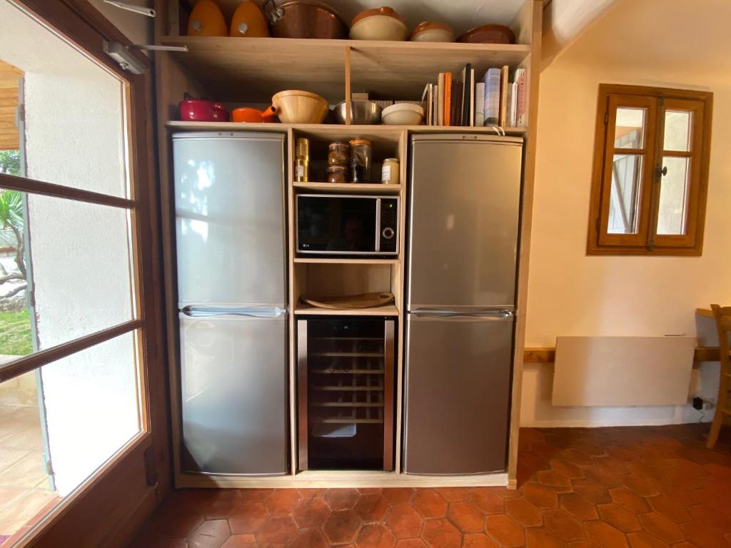 a refrigerator in a kitchen with a door open at Campagne Salettes in Lorgues