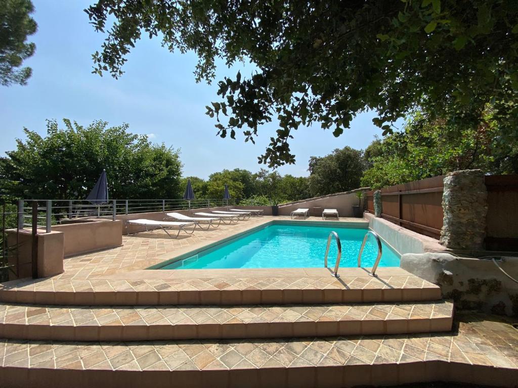 a swimming pool with stairs leading to at Campagne Salettes in Lorgues