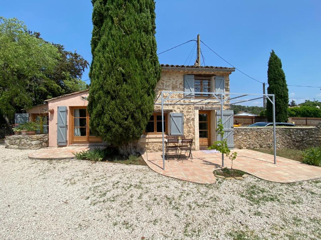 a house with a large tree in front of it at Campagne Salettes in Lorgues