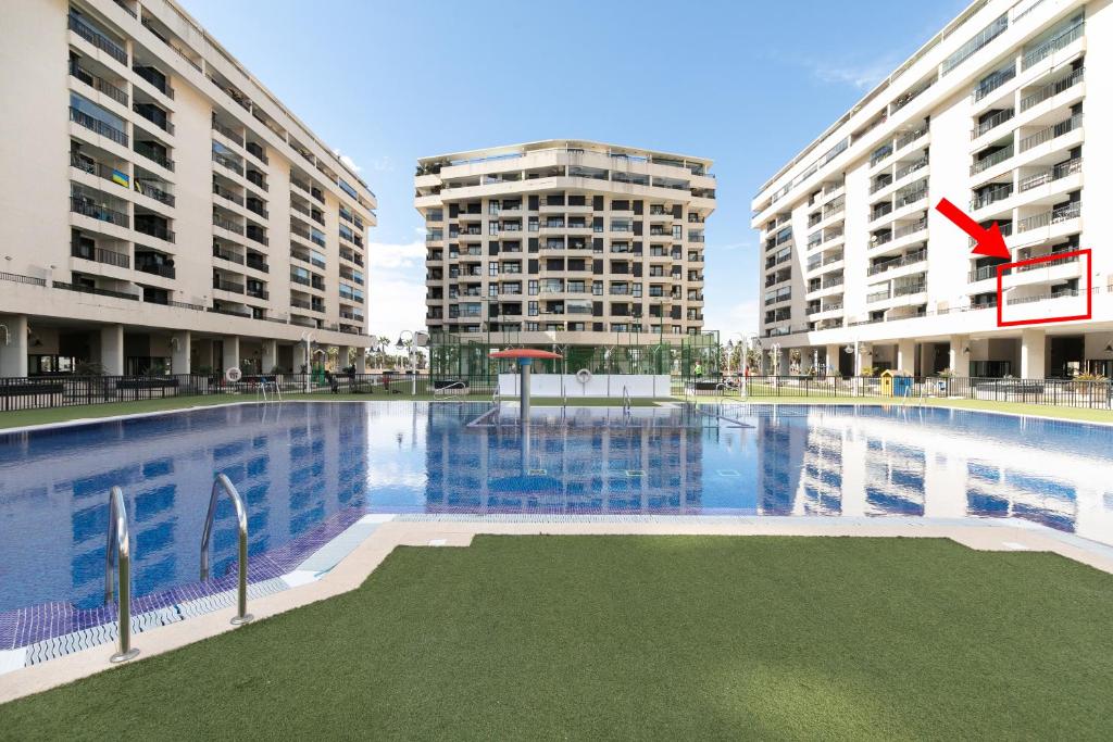 a view of two tall buildings and a swimming pool at Veramar Beach Apartment in Valencia