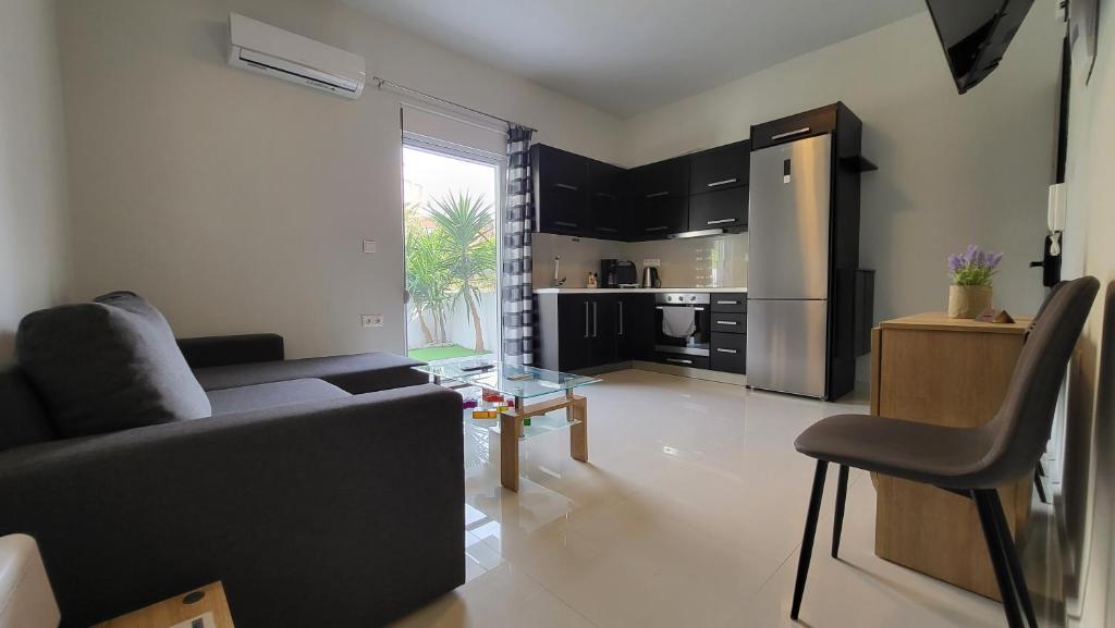 a living room with a couch and a kitchen at Konnet Apartment in Rhodes Town