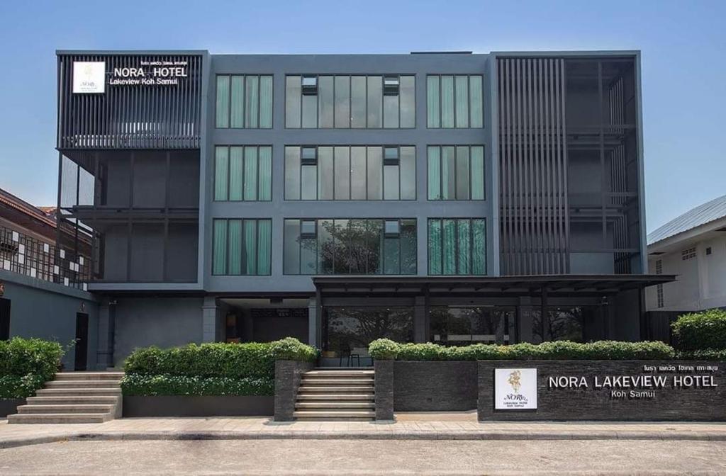 a large black building with stairs in front of it at Nora LakeView in Chaweng