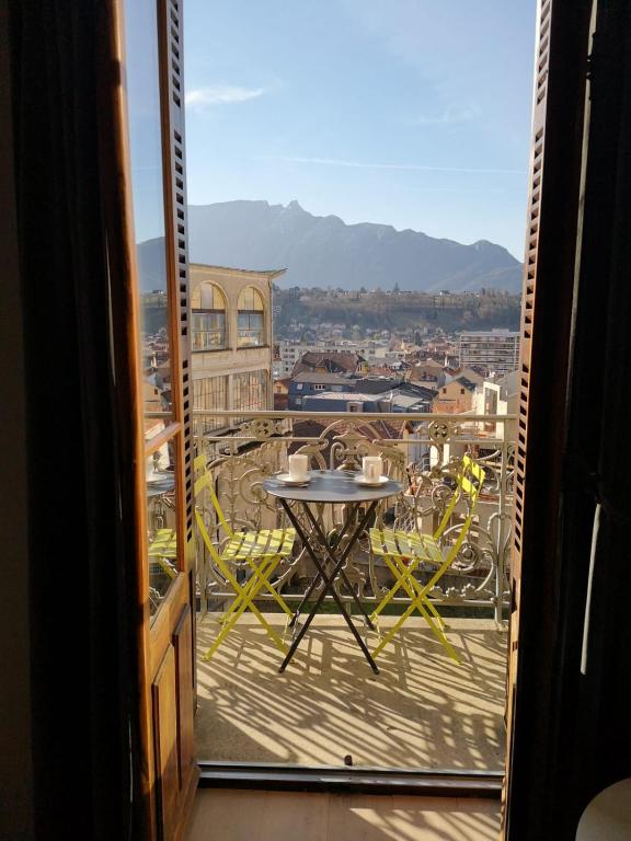 a view of a balcony with a table and chairs at Villa Saint Enogat in Aix-les-Bains