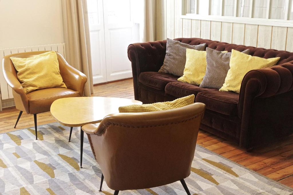 - un salon avec deux canapés, une table et des chaises dans l'établissement Galeries - Appartement 2 chambres avec Parking, à Bordeaux