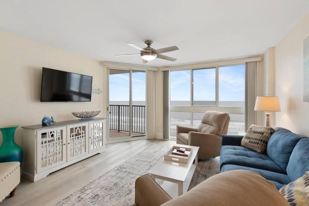 a living room with a blue couch and a tv at Pinnacle #503 Oceanfront*Enclosed Outdoor Pool*NEW Updates!, 2022 Updates-Pinnacle #503 OceanFront*E in Myrtle Beach