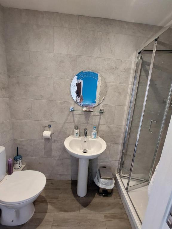 a bathroom with a sink and a shower at Westbrook Lodge Guest House in Margate