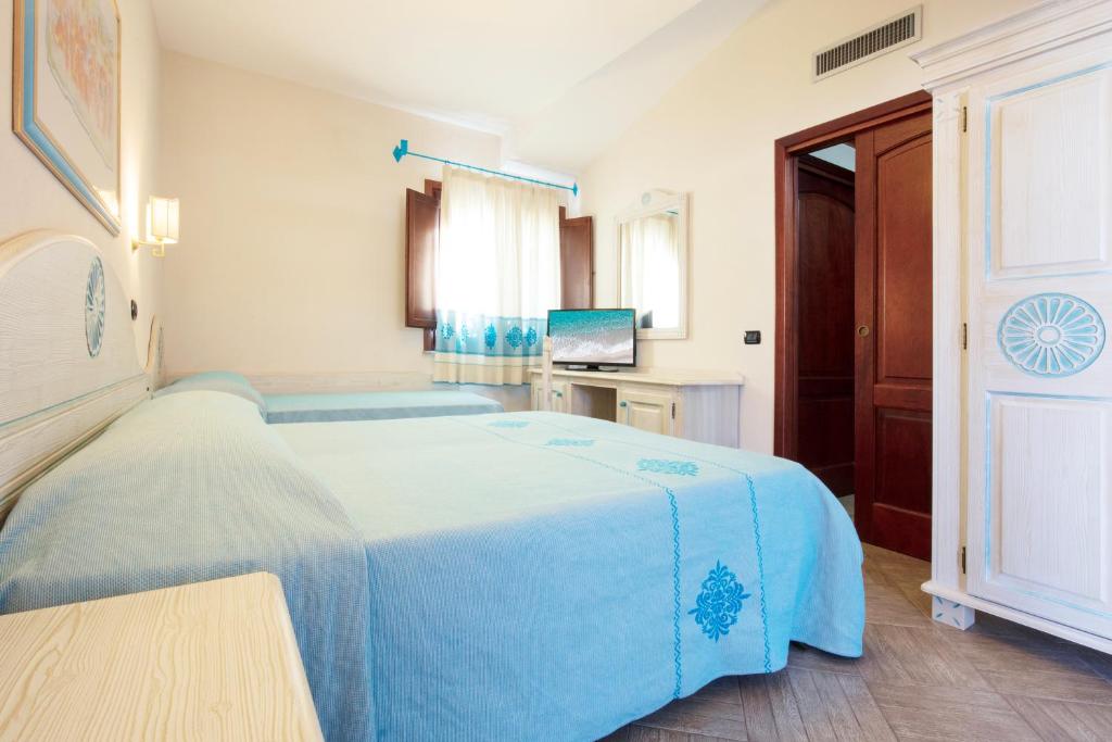 Posteľ alebo postele v izbe v ubytovaní Marina Torre Navarrese Resort