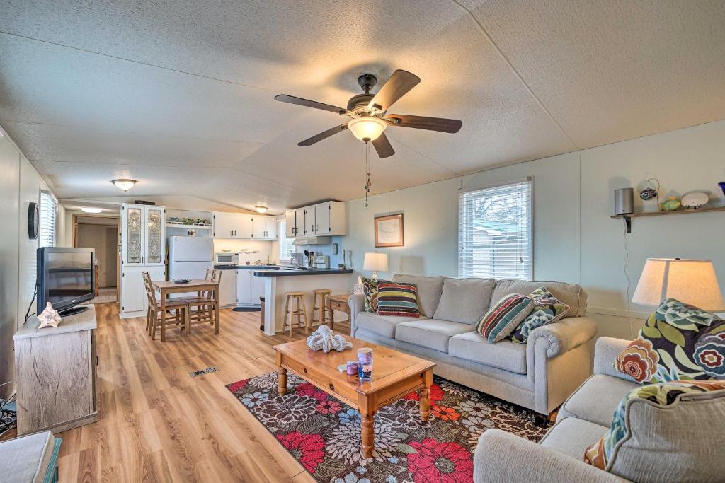 a living room with a couch and a table at Peaceful Supply House about 2 Mi to Holden Beach! in Supply