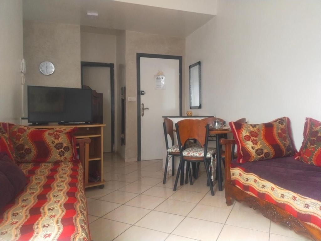 a living room with a couch and a table at Entire Apartment in Agadir