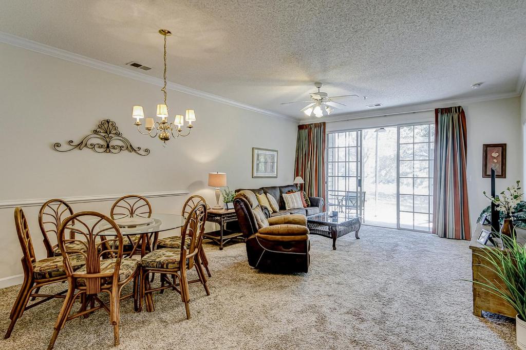 a dining room and living room with a table and chairs at The Havens 1512 in North Myrtle Beach