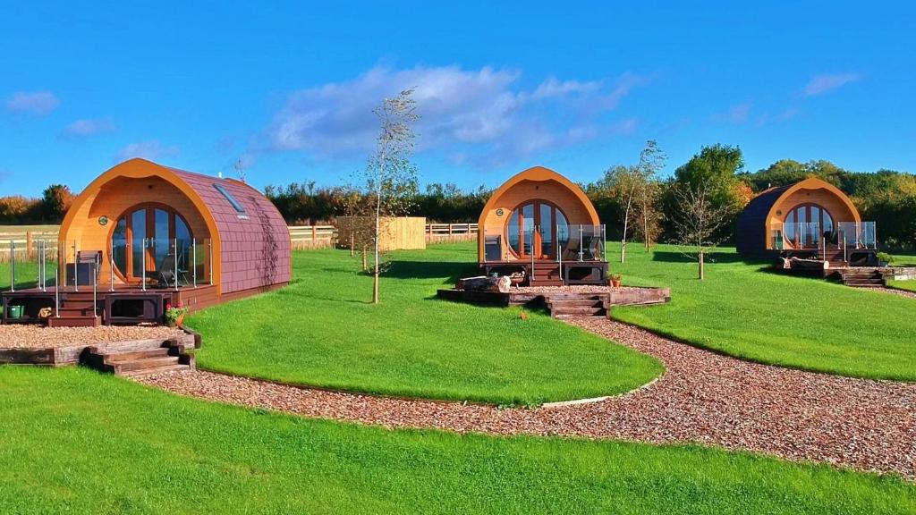 a group of three yurt homes in a field at Finest Retreats - Worm Dale in York