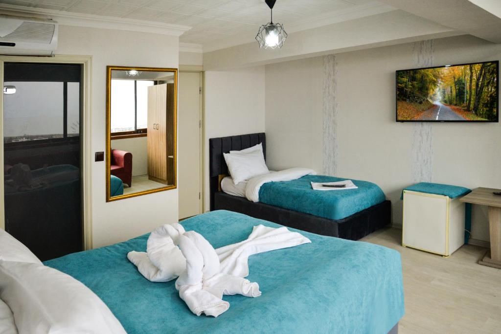 Postel nebo postele na pokoji v ubytování Elite Holiday Hotel