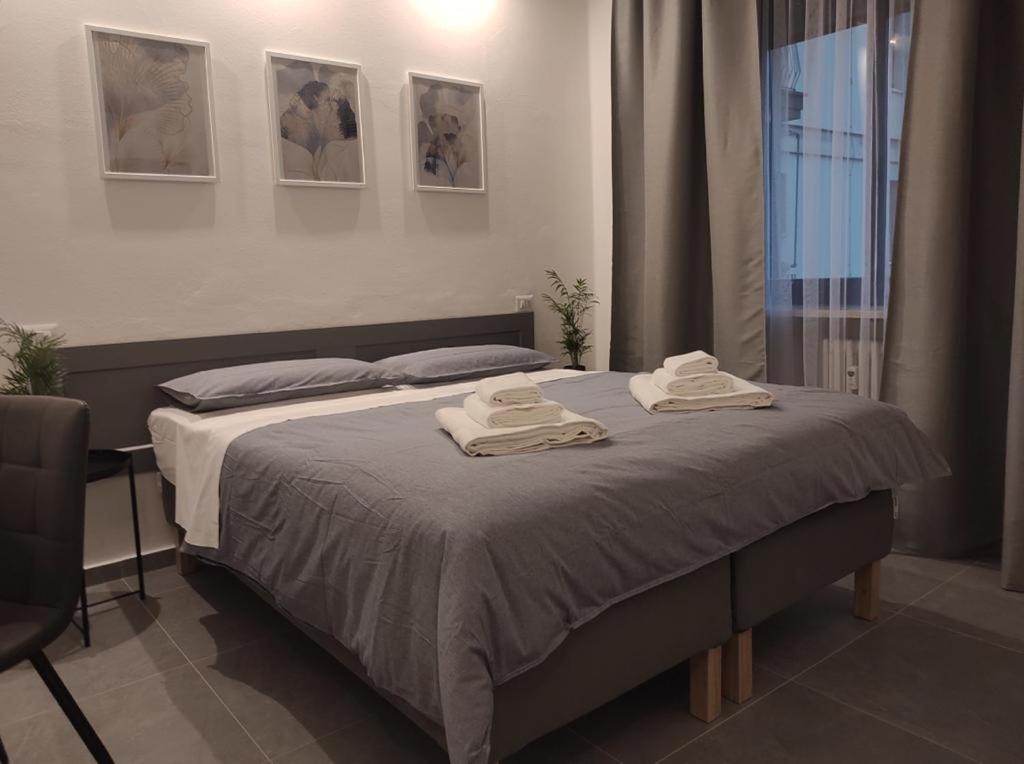 a bedroom with a bed with two towels on it at Residenza Via Verdi in Parma