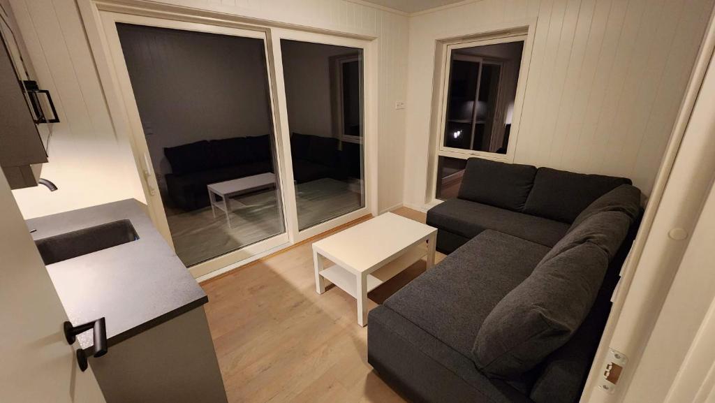 a living room with a couch and a table at Torghatten bnb in Brønnøysund