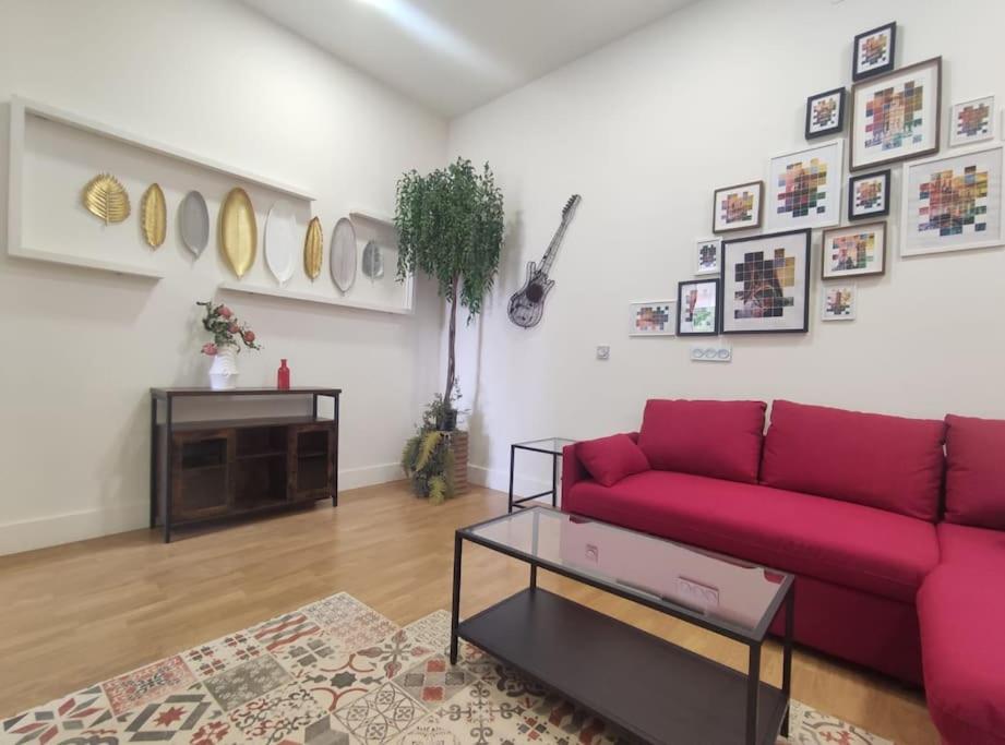 a living room with a red couch and a table at SmartTrip in Seville