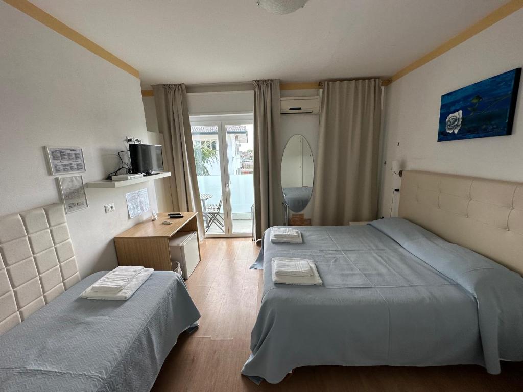 Postel nebo postele na pokoji v ubytování Hotel Irene