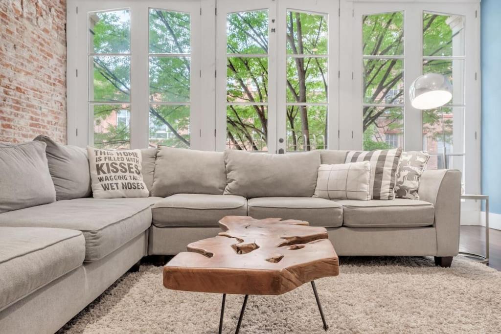 a living room with a couch and a coffee table at Stunning Old City 2 Bedroom - Elevator, Bay Windows in Philadelphia