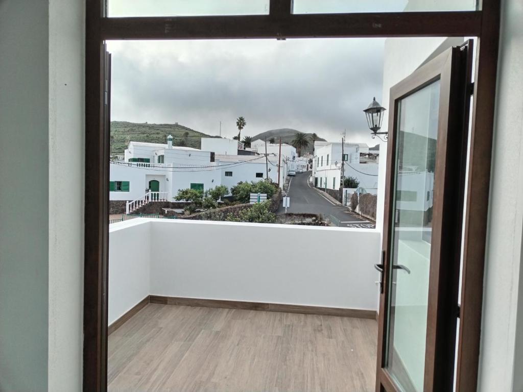 a view from the balcony of a house with a glass door at Casa Isidro in Haría