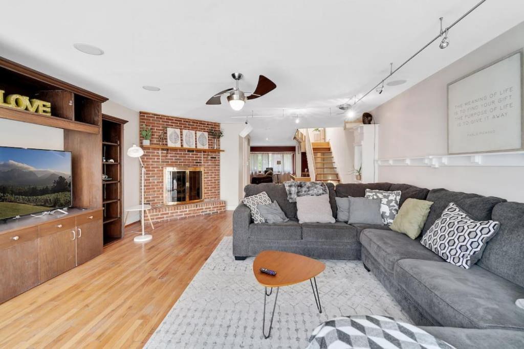a living room with a couch and a tv at Society Hill 4 Bedroom with Garage Parking in Philadelphia