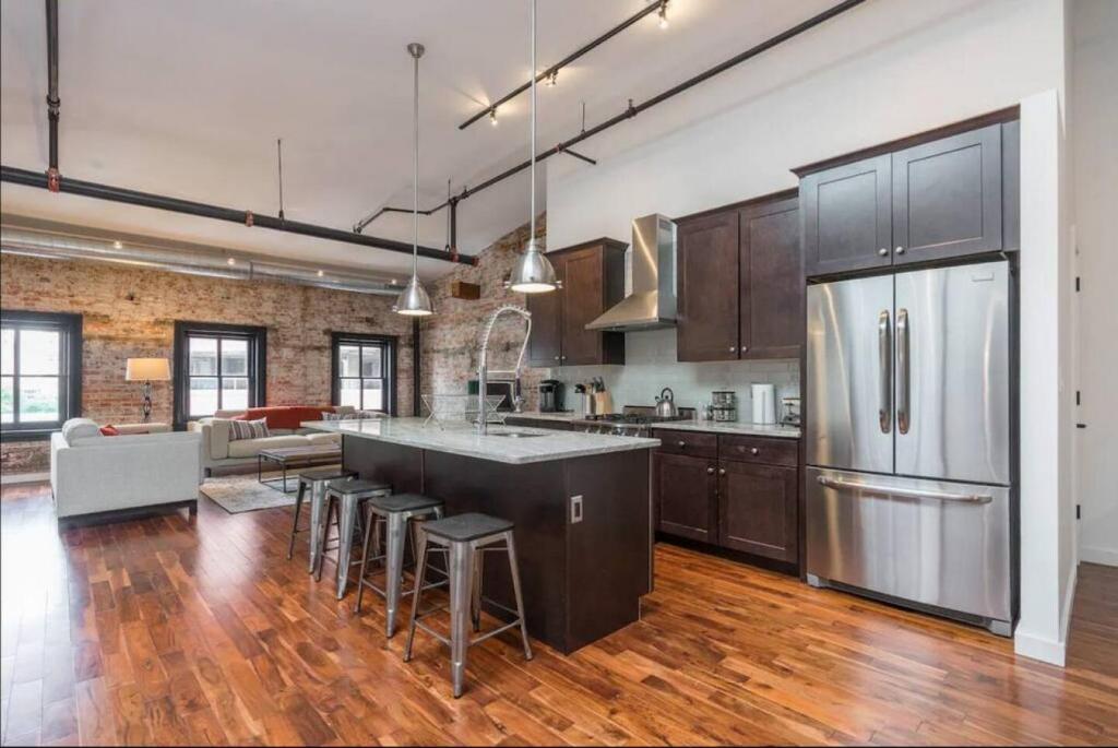 a large kitchen with a refrigerator and a table at Luxurious Million Dollar Penthouse with Elevator and Parking in Philadelphia