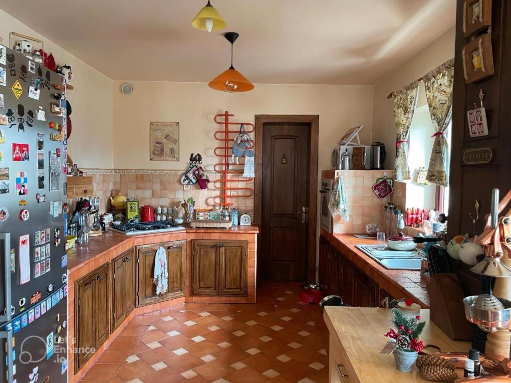 a kitchen with wooden cabinets and a refrigerator at Blue Sky in Buşteni