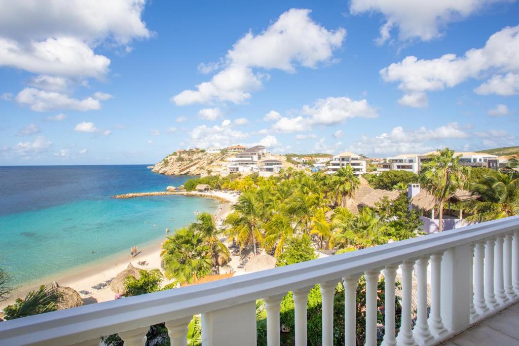 a view of the beach from the balcony of a resort at Blue Bay Beach Apartments in Blue Bay