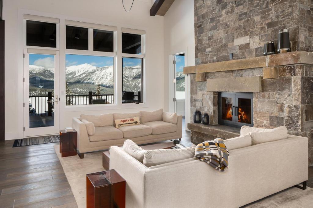 a living room with two couches and a fireplace at Inspiration Point Townhome 8C in Big Sky