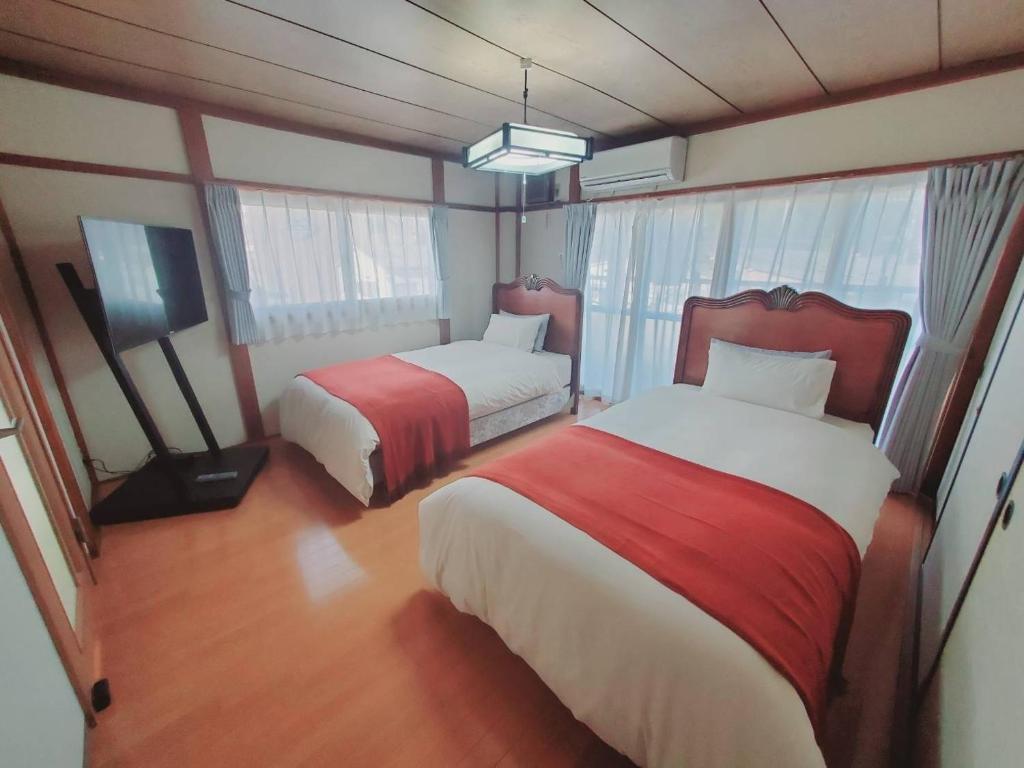 a hotel room with two beds and a television at Corp Temma - Vacation STAY 08268v in Takayama