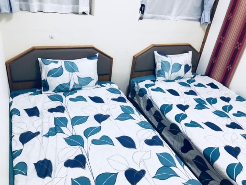 deux lits côte à côte dans une chambre dans l'établissement Ishigakijima no Sudomari Orihimeno Yado - Vacation STAY 72074v, à Ishigaki