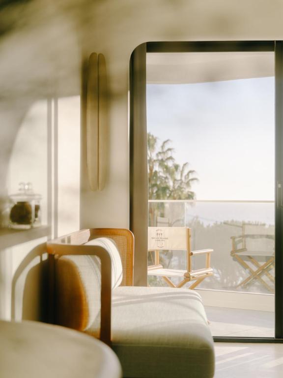 a room with two chairs and a window at Hôtel & Spa Belle Plage in Cannes