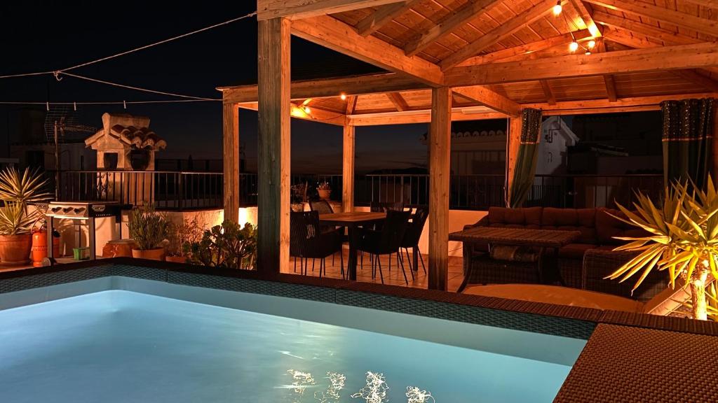 a swimming pool in the middle of a patio at night at Casa Palma in Cómpeta