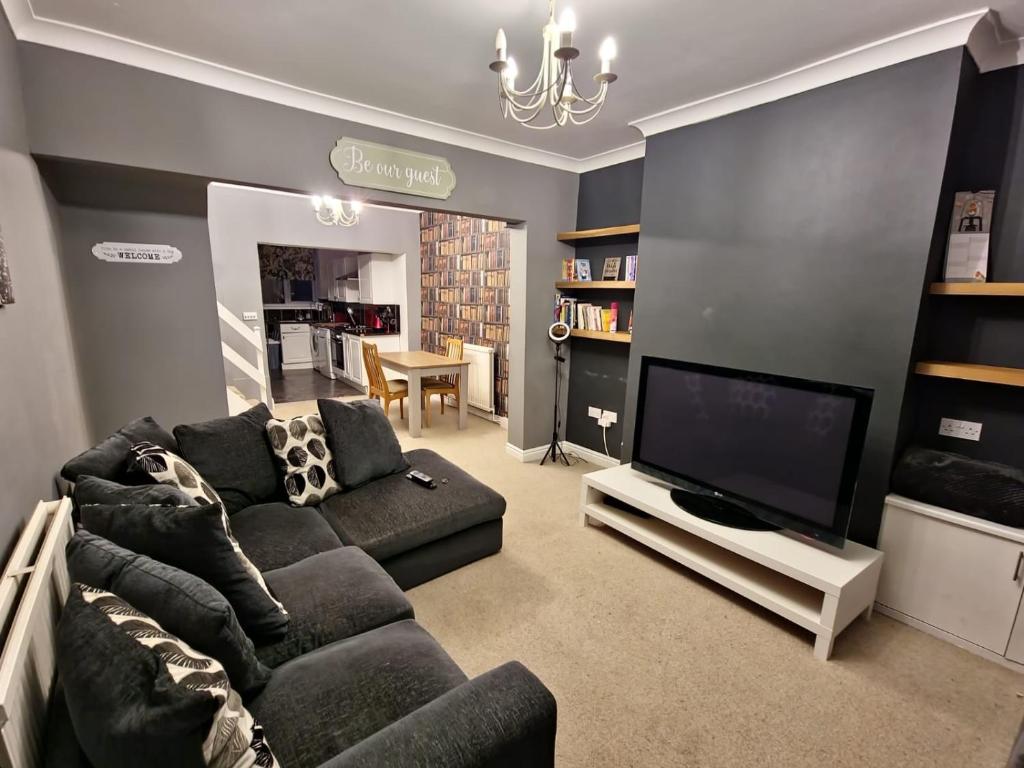 a living room with a couch and a flat screen tv at 1 bedroom Sculcoates house Hull in Hull