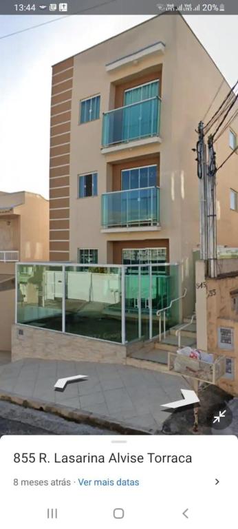 a building with a balcony in front of it at Ap 11 amarílis in Poços de Caldas