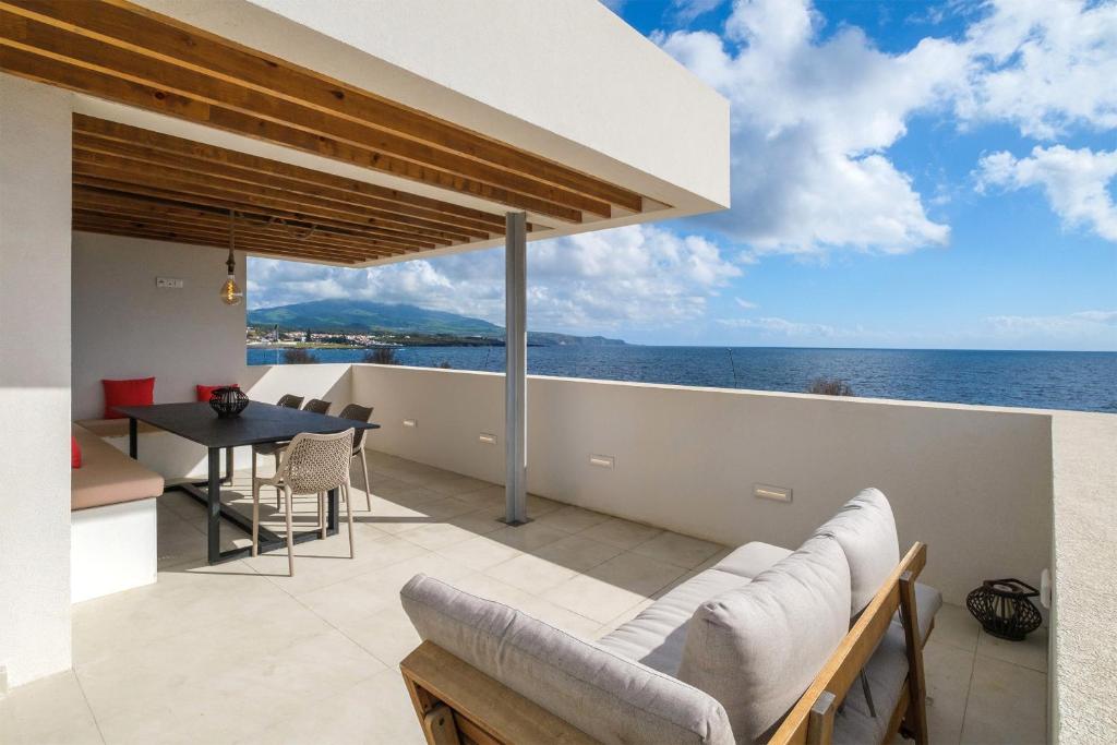 a view of the ocean from the balcony of a house at Casa dos Pedros (Beach House) in São Roque