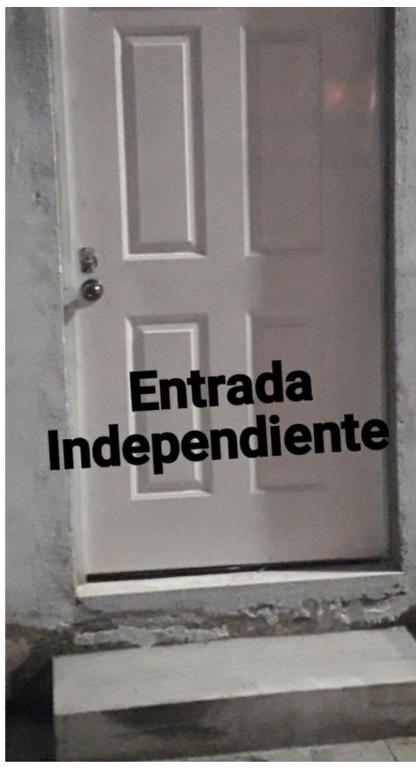 a door with the words enidario independence written on it at La Habitacion. in Celaya