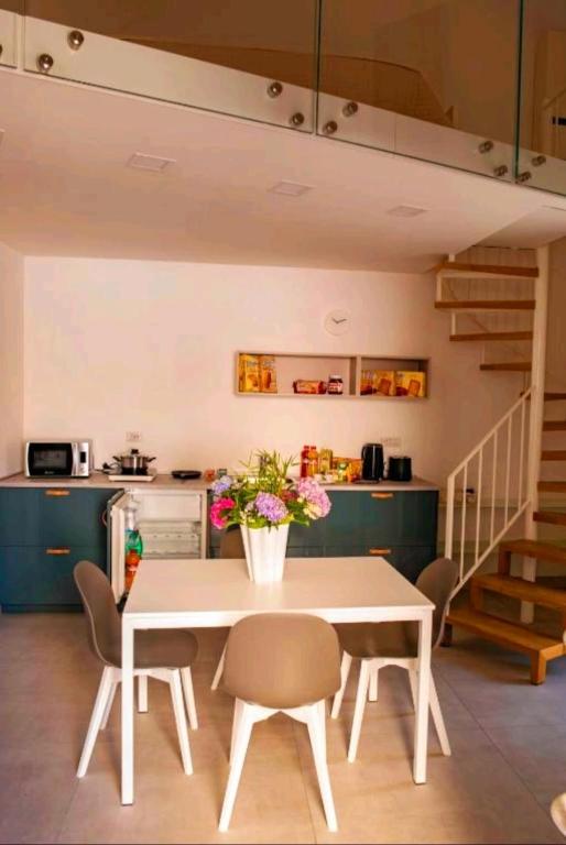 a kitchen and dining room with a table and chairs at SANT'ANTIDA APARTMENT in Caserta