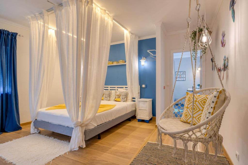 a bedroom with a canopy bed and a swing at Pillows Peniche B&B in Peniche