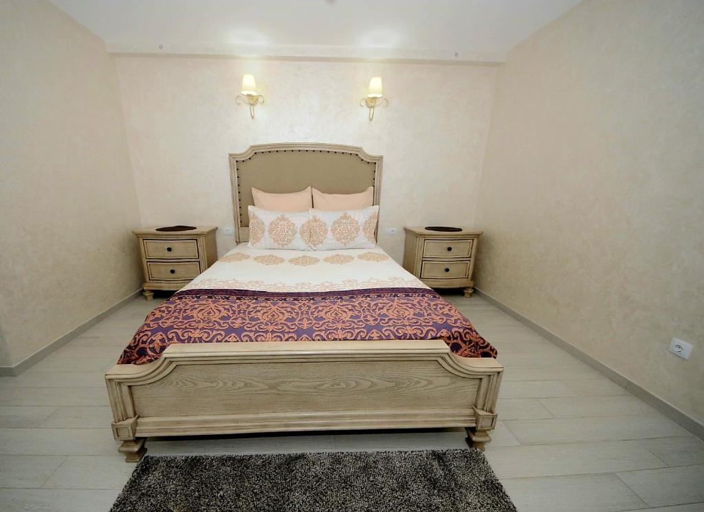 a bedroom with a large bed with two night stands at Apartament Panoramic in Galaţi