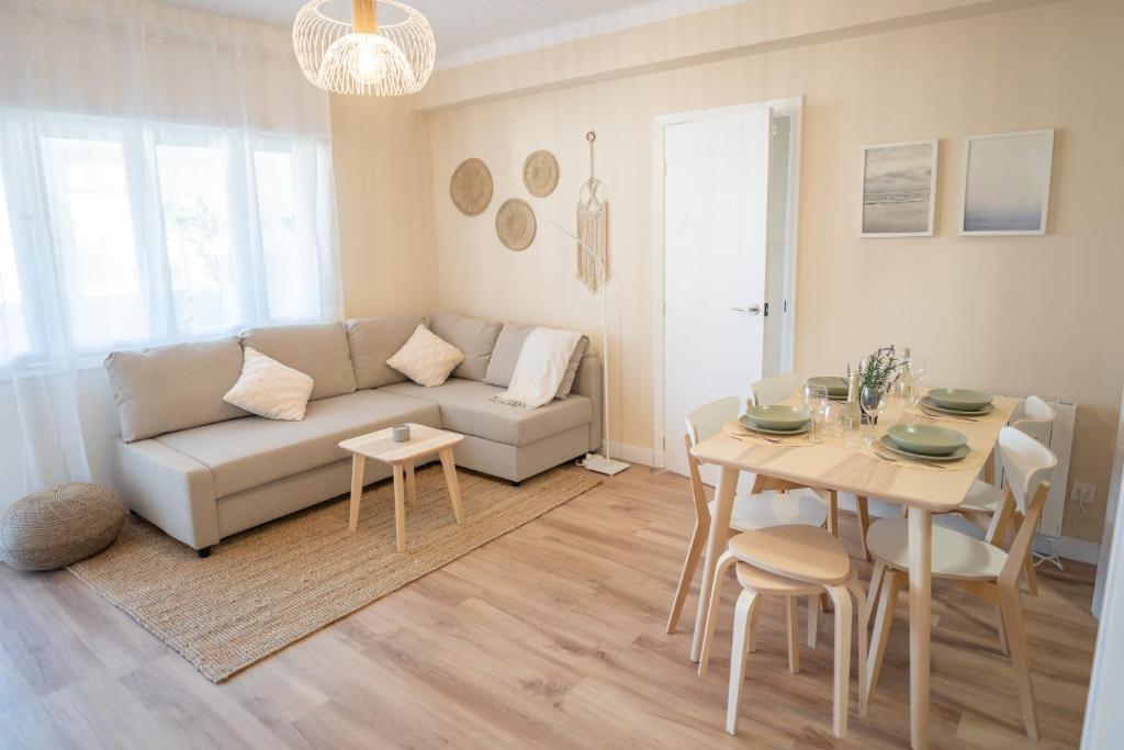 ein Wohnzimmer mit einem Sofa und einem Tisch in der Unterkunft SAMIL PLAYA SUR in Vigo