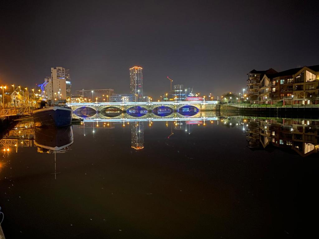 a bridge over a river with a city at night at LoughView BED & BREAKFAST in Belfast