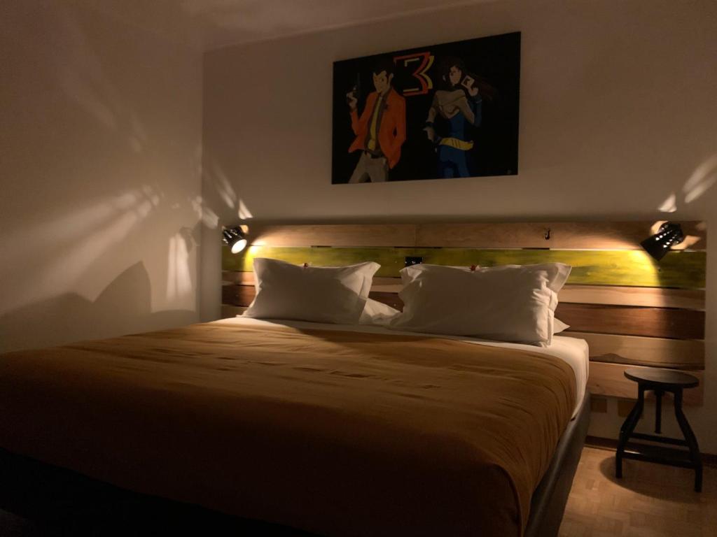 a bedroom with a large bed with lights on it at BB Bis in Candelo