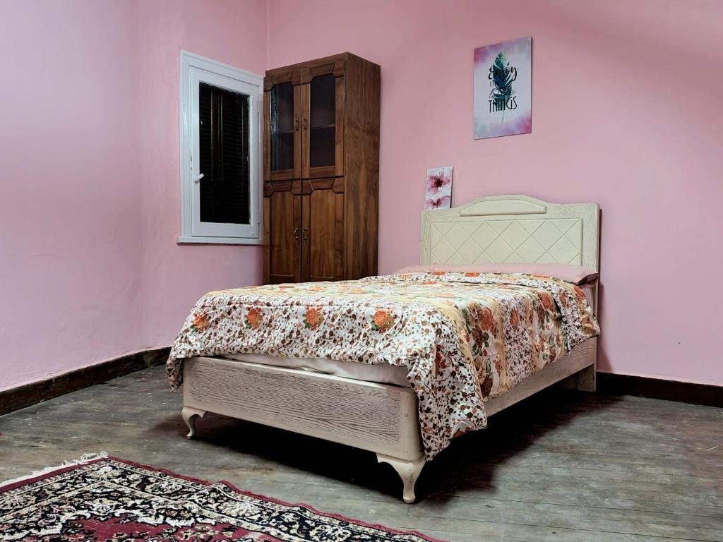 a bedroom with a bed in a pink wall at Special Room in downtown Cairo in Cairo