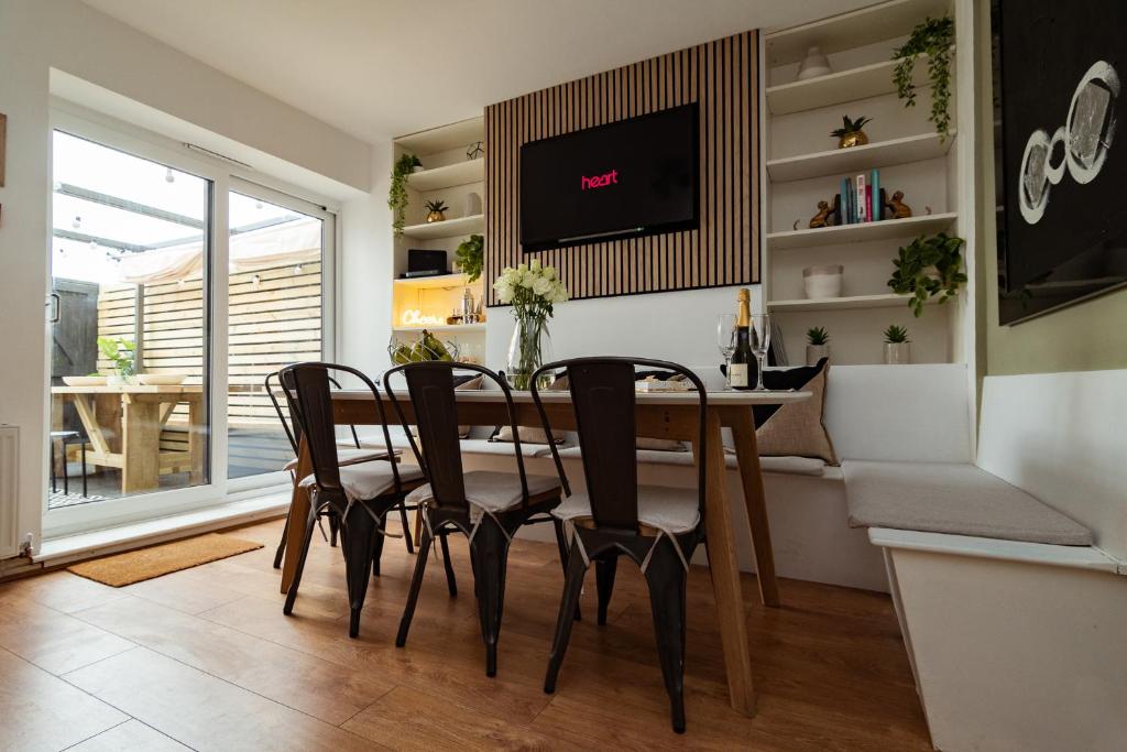 a dining room with a table and chairs and a tv at south view in Bournemouth